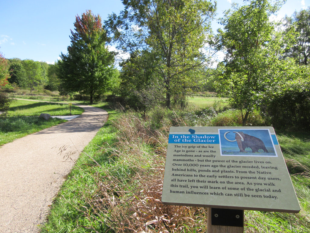 This Sept. 26, 2016 photo shows a sign in a park in Delafield, Wis., describing how retreating glaciers sculpted the landscape.