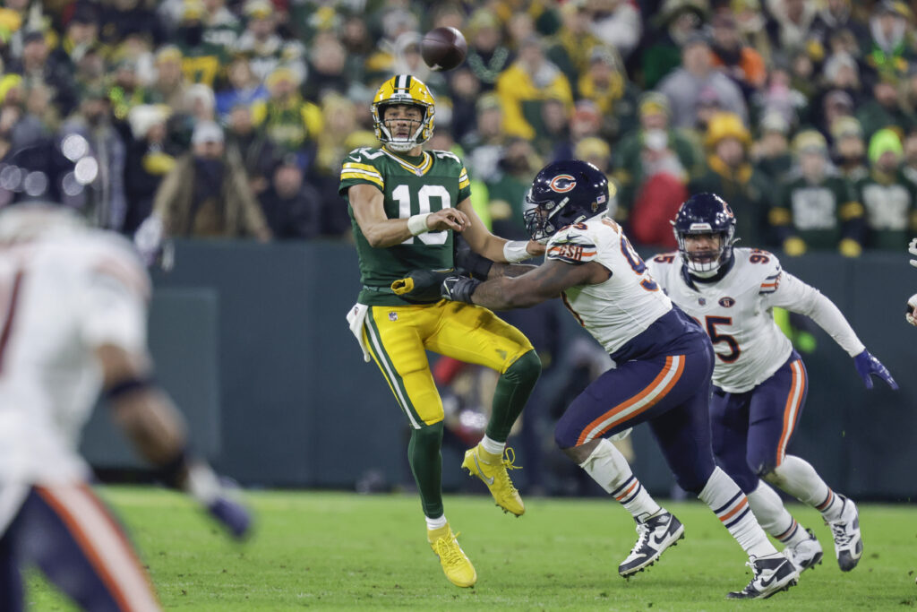 Green Bay Packers quarterback Jordan Love gets tackled by Justin Jones of the Chicago Bears during an NFL game