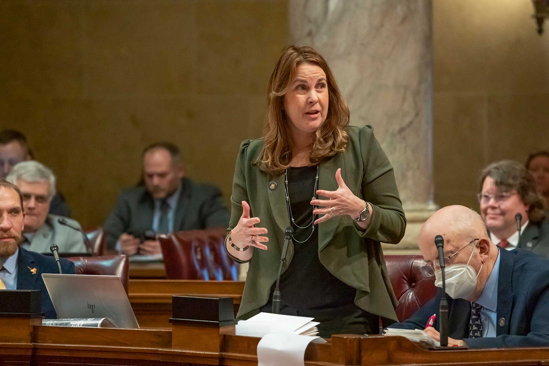 Sen. Hesselbein speaking on Senate floor, surrounded by fellow legislators