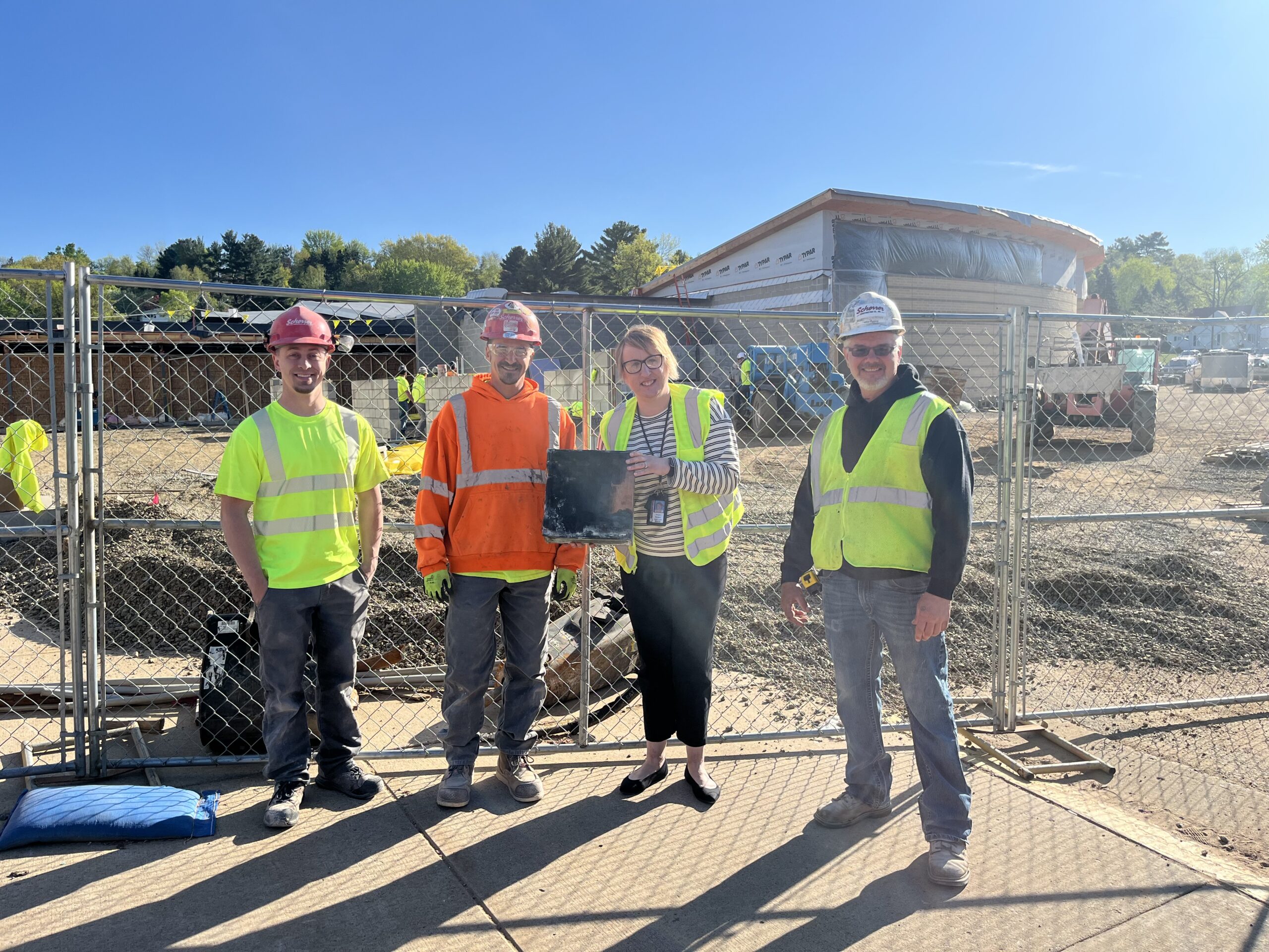 Principal Angela Rodgers of Wausau's John Muir Middle School, second from right, holds a time capsule from 1961 that construction crews found in the school's cornerstone.