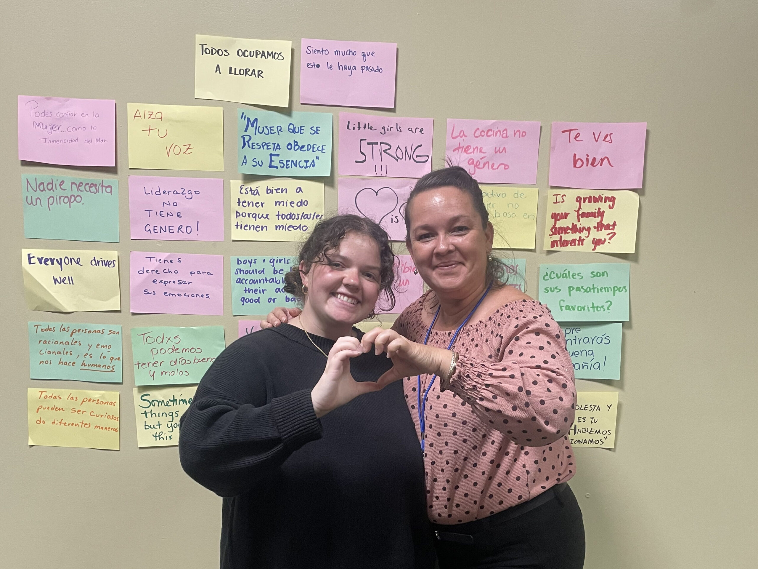 Miya Marwood makes a heart shape with her hands alongside a high school counselor in Costa Rica.