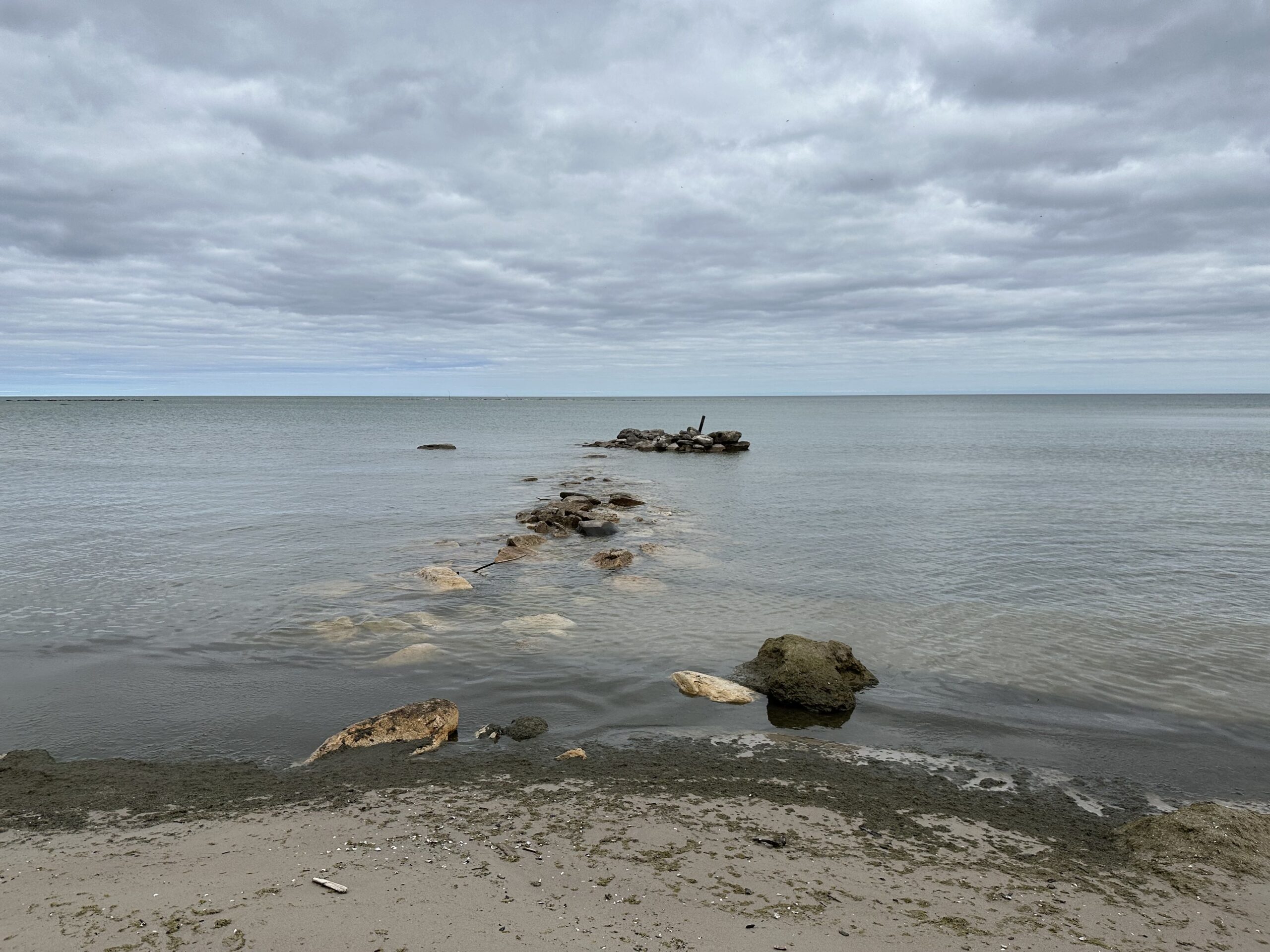 The ruins of a small lumber pier extend into Duck Bay at Bohemia Town (late 19th century), now in Newport State Park.