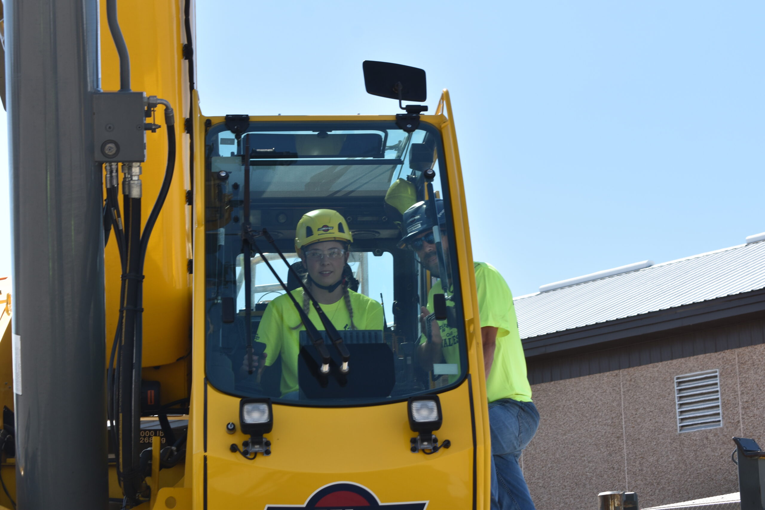 A student operates a crane at Miron Construction's annual Build Like a Girl event.