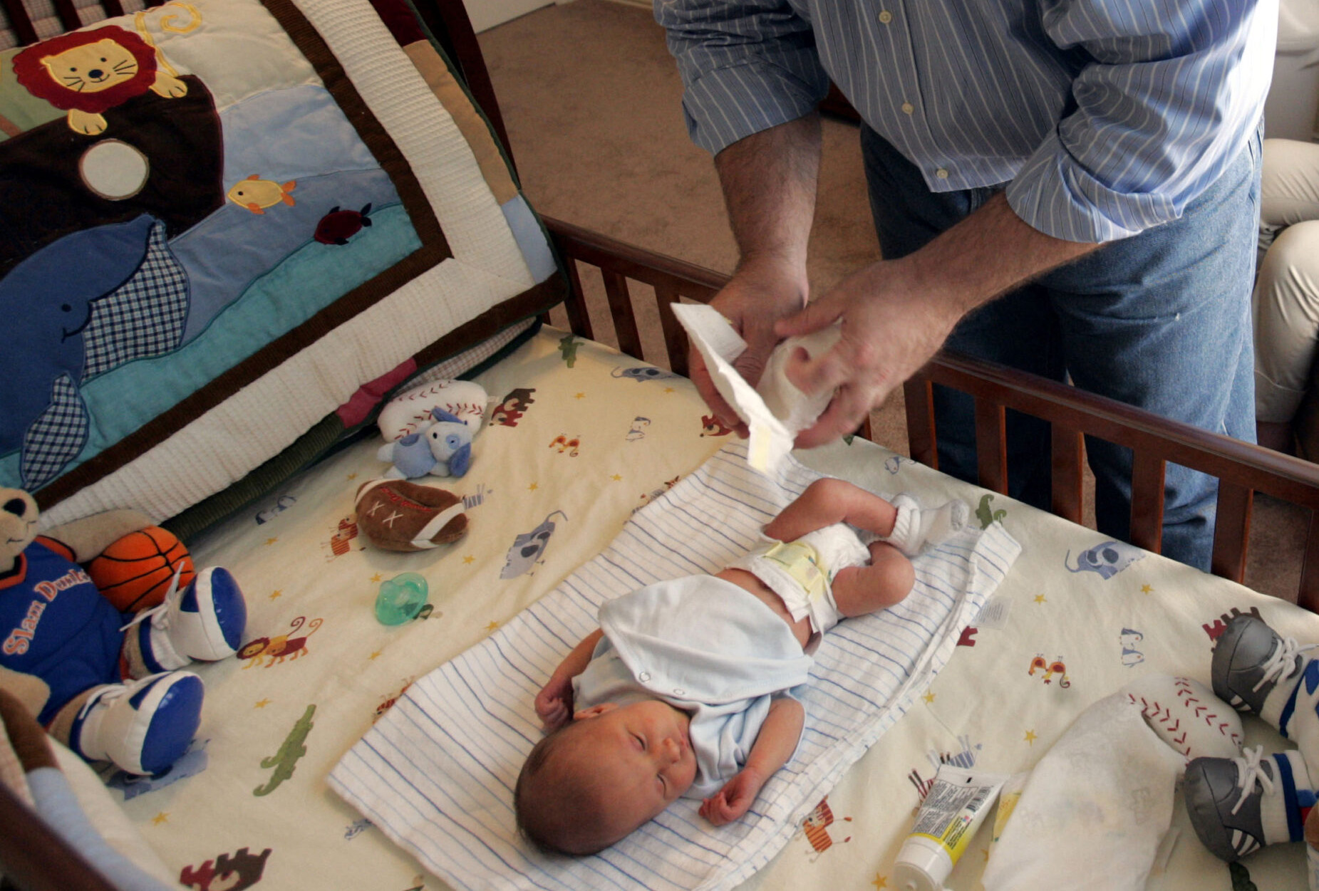 A dad changes his newborn son's diaper. AP Photo/Donna McWilliam