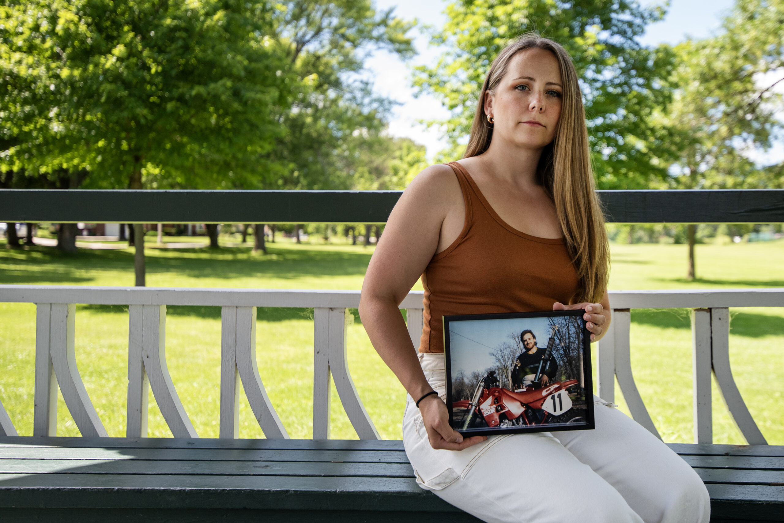 Megan Hoffmann Kolb sits and holds a photo of her father, Dean Hoffmann
