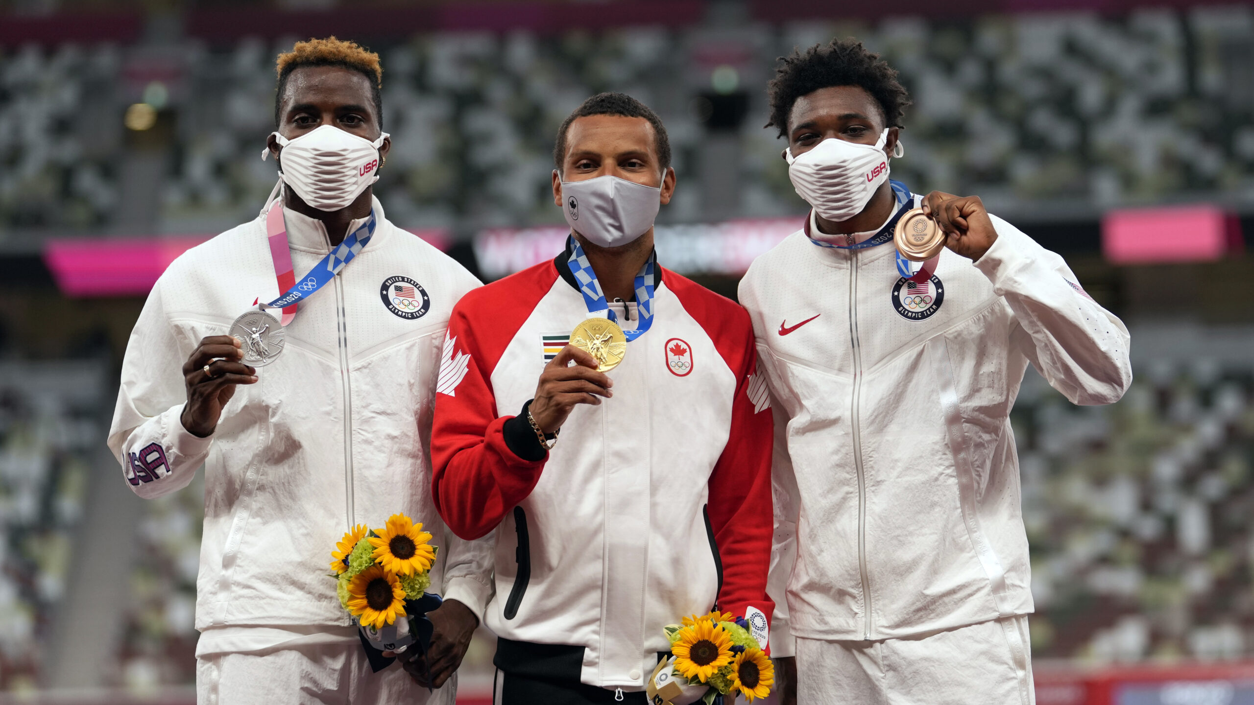 Gold medalist Andre De Grasse, of Canada, center, stands with silver medalist Kenneth Bednarek, of the United States, left, and bronze medalist Noah Lyles, of the United States, during the medal ceremony for the men's 200-meter at the 2020 Summer Olympics, Thursday, Aug. 5, 2021, in Tokyo. (AP Photo/Martin Meissner)