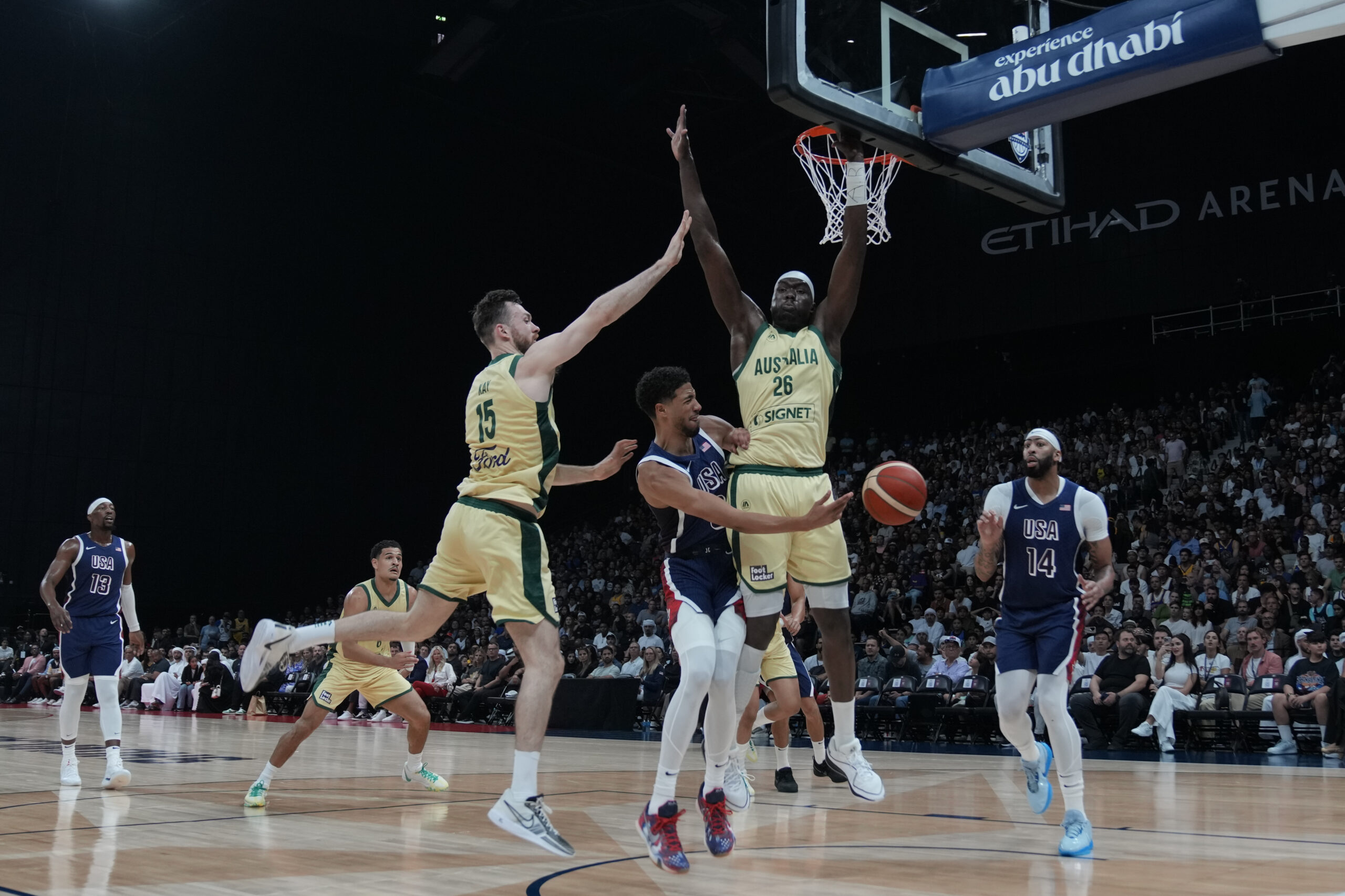 Tyrese Haliburton, center, is defended by Australia's Nick Kay (15) and Duop Reath (26) during the USA Basketball Showcase in Abu Dhabi, United Arab Emirates, Monday, July 15, 2024.