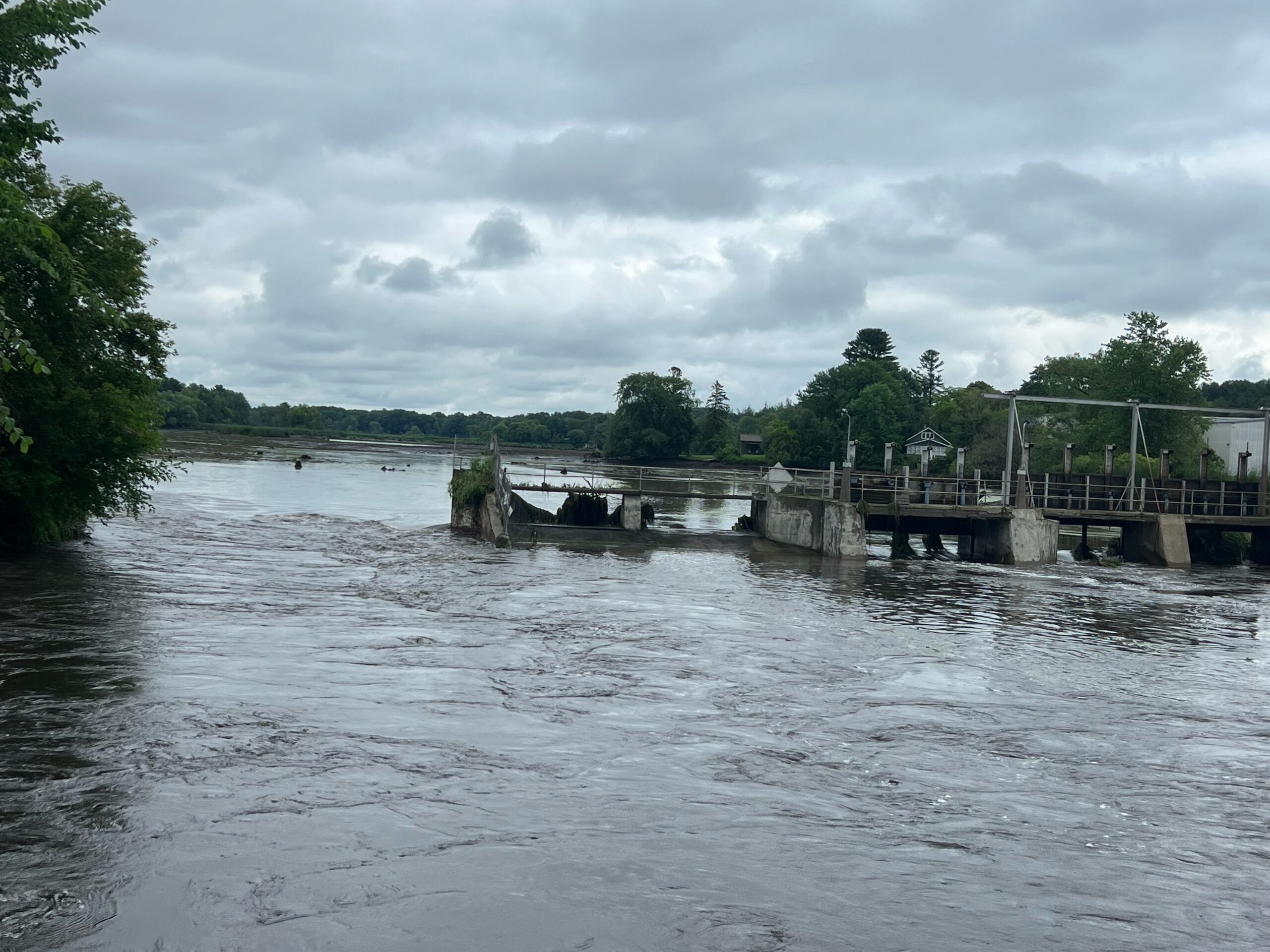 Floodwaters pass through breached dam