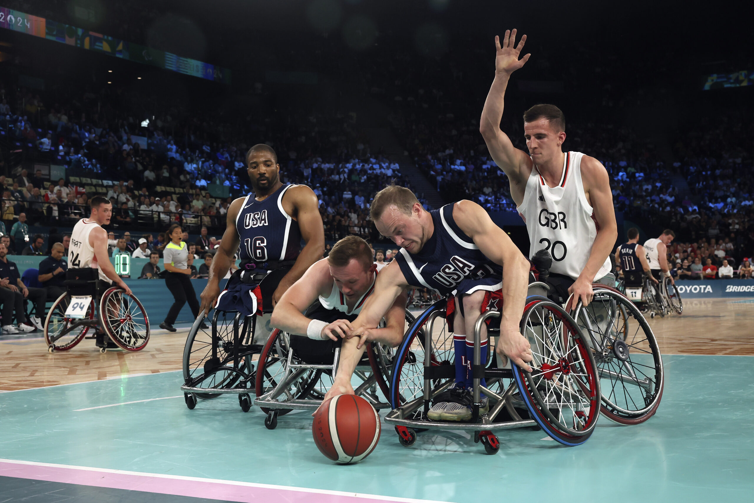 John Boie of the U.S., foreground right, and Britain's Ben Fox fight for the ball during the wheelchair basketball men's gold medal match at the 2024 Paralympics, Saturday, Sept. 7, 2024, in Paris, France.