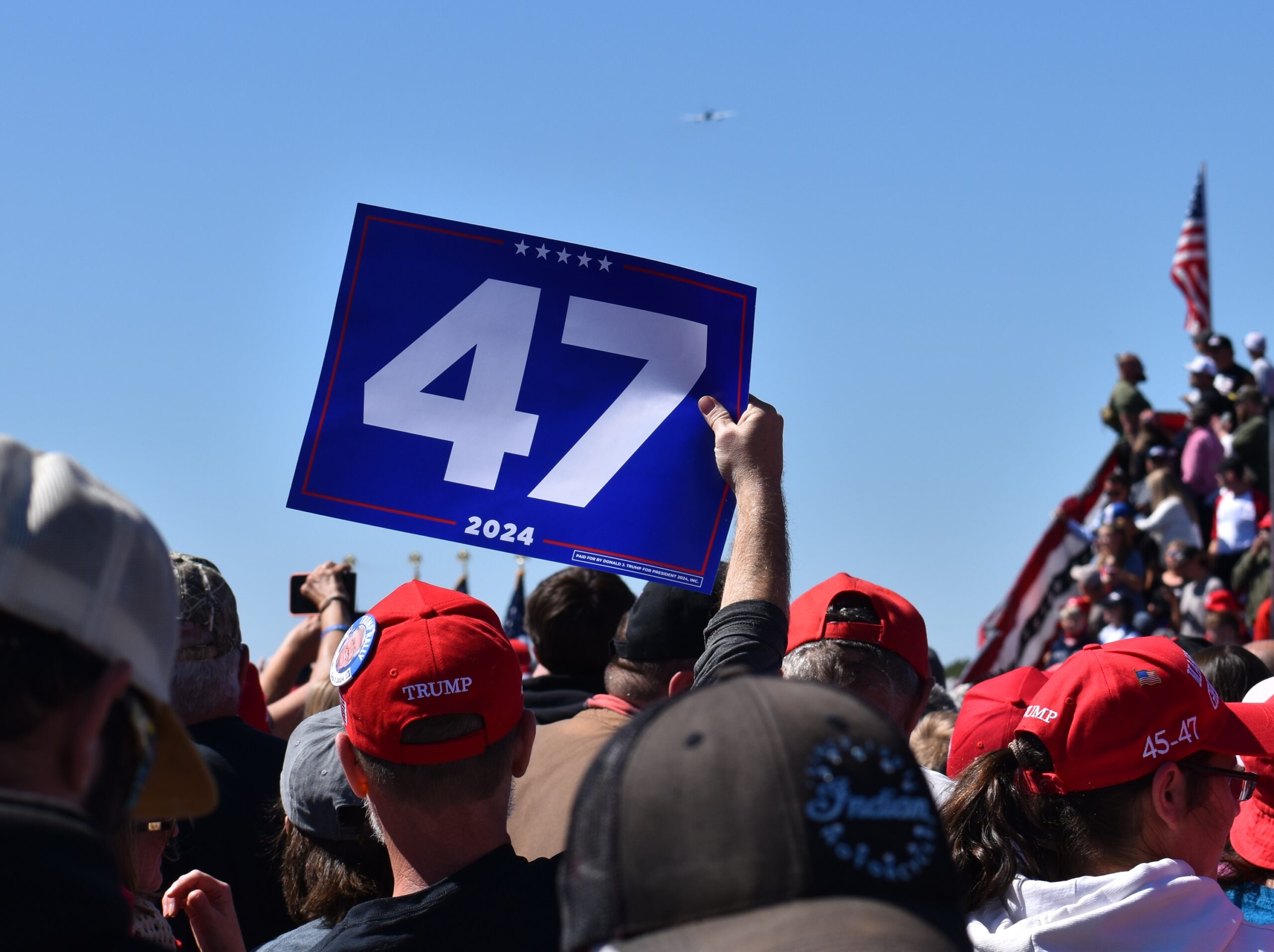 A rally attendee waves a sign reading '47' at Republican presidential nominee Donald Trump's campaign event in Mosinee.