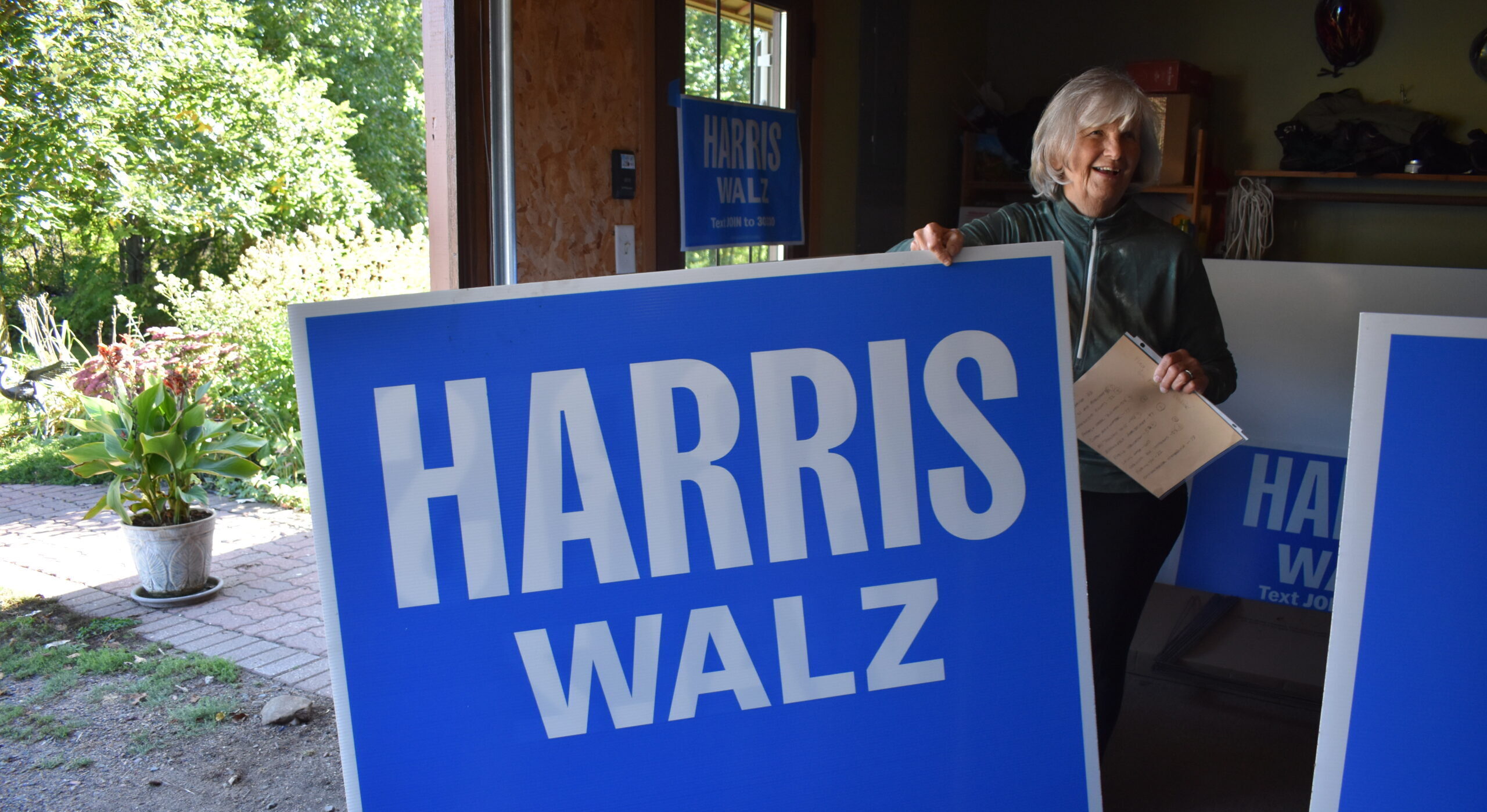 Peggy Stalheim of the Taylor County Democratic Party is distributing Harris-Walz campaign signs out of her garage.