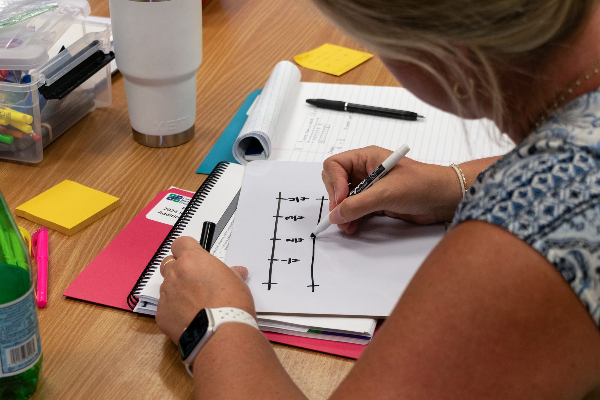 A Milwaukee teacher uses a number line to demonstrate adding and subtracting fractions