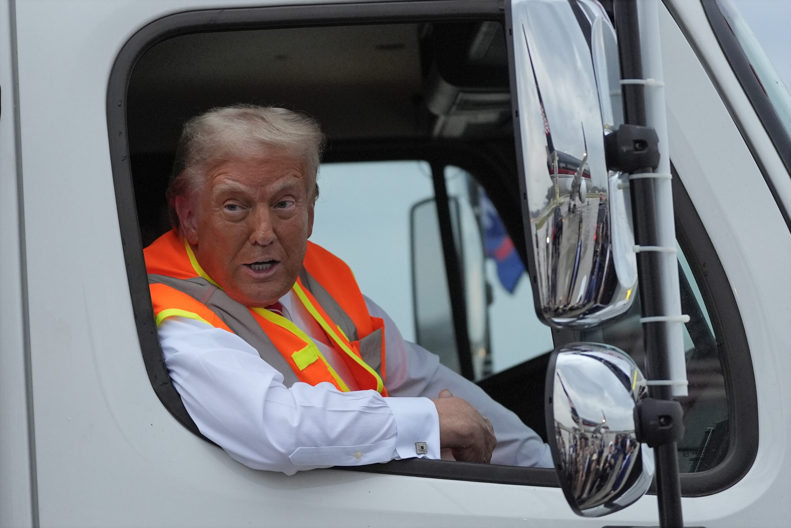 Republican presidential nominee former President Donald Trump talks to reporters as he sits in a garbage truck Wednesday, Oct. 30, 2024, in Green Bay, Wis.