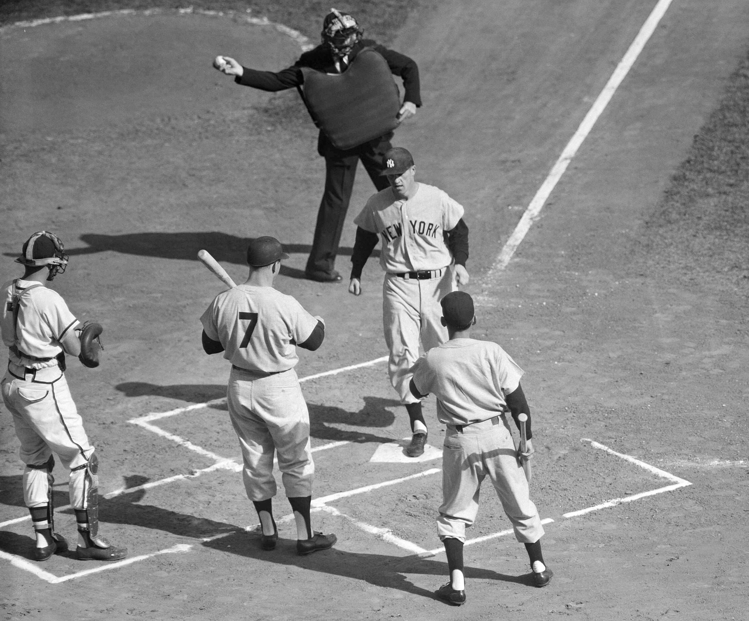 Tony Kubek, Yankees player who is from Milwaukee, scores with first inning homer, Oct. 5, 1957 in County Stadium, Wis., in third game of World Series. Greeting him are Mickey Mantle (7), and bat boy. <em>AP Photo</em>