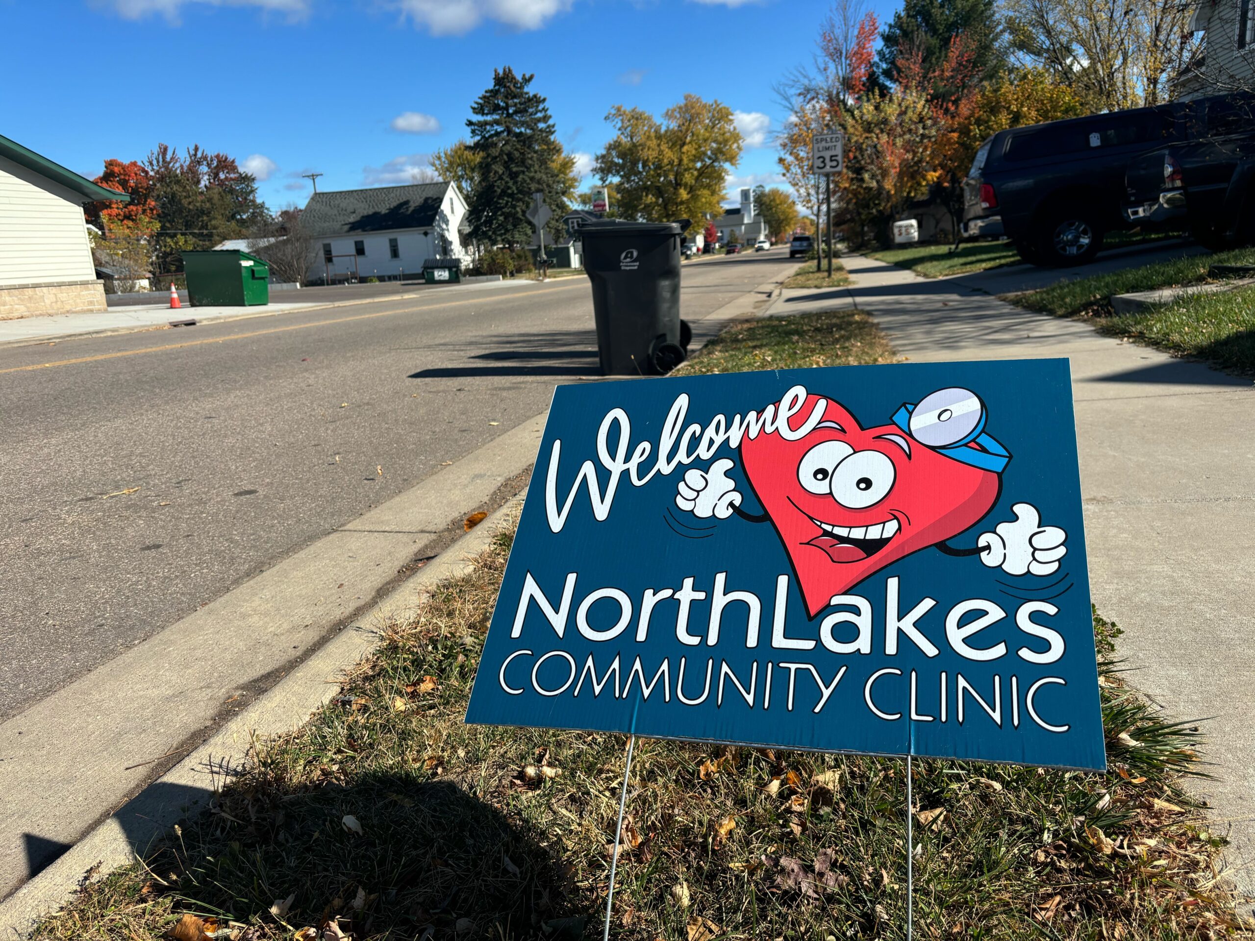 a blue yard sign with a pink heart