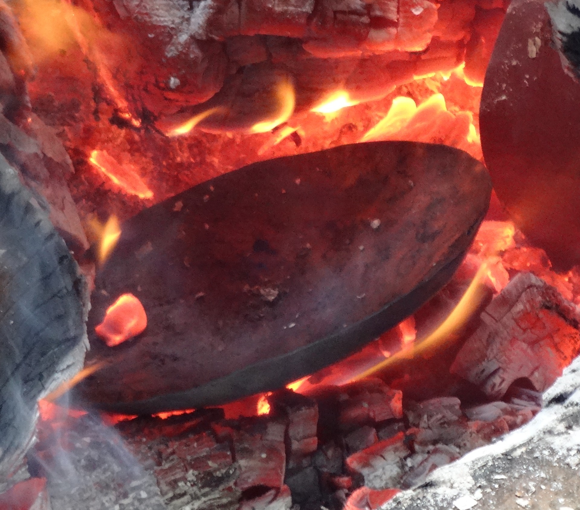 A bowl is slowly cooling in a wood fire. (Courtesy Martha Buche)