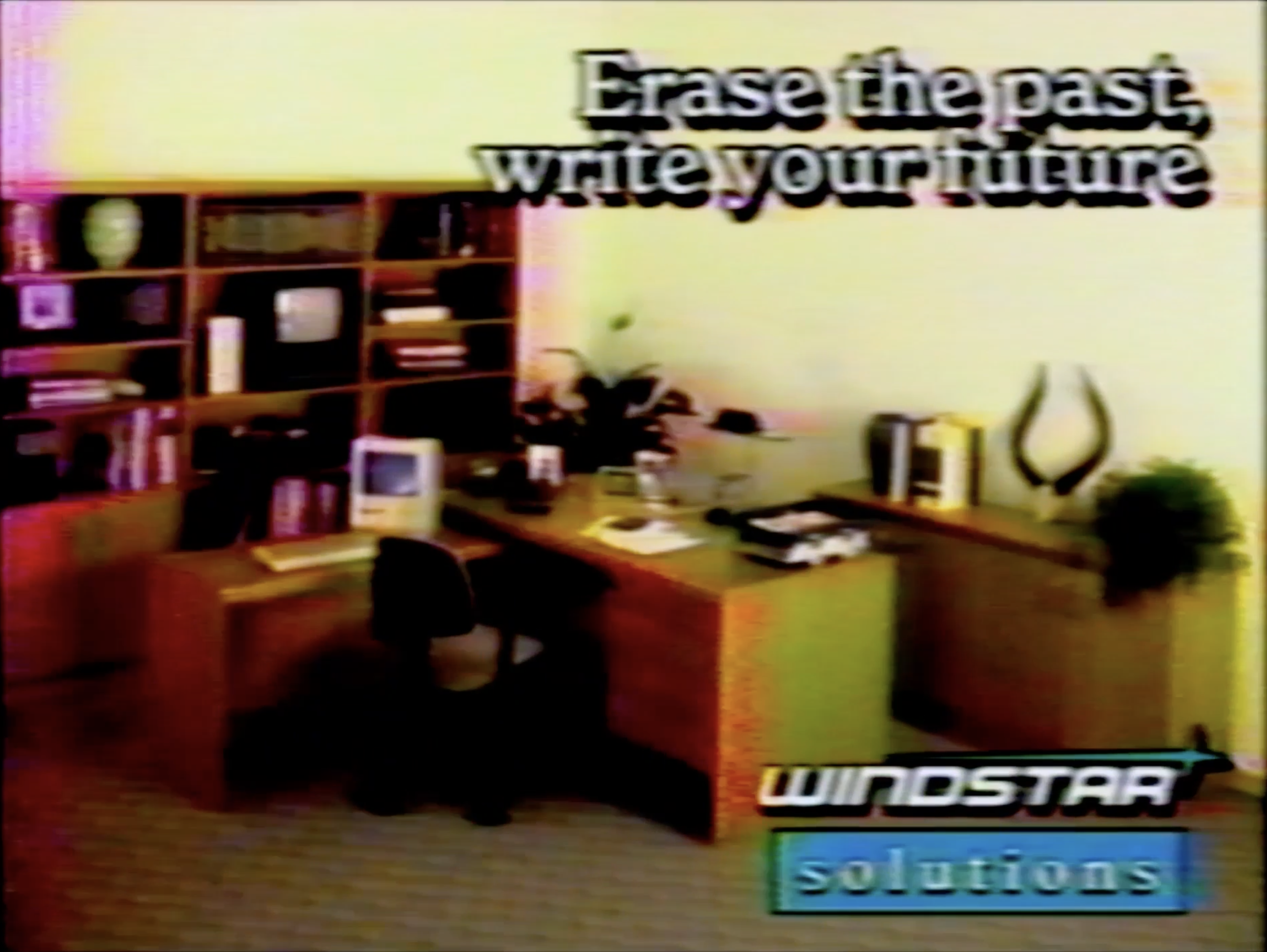 Office with wooden desk, chair, computer, and bookshelf. Text reads Erase the past, write your future with Windstar Solutions logo at the bottom.