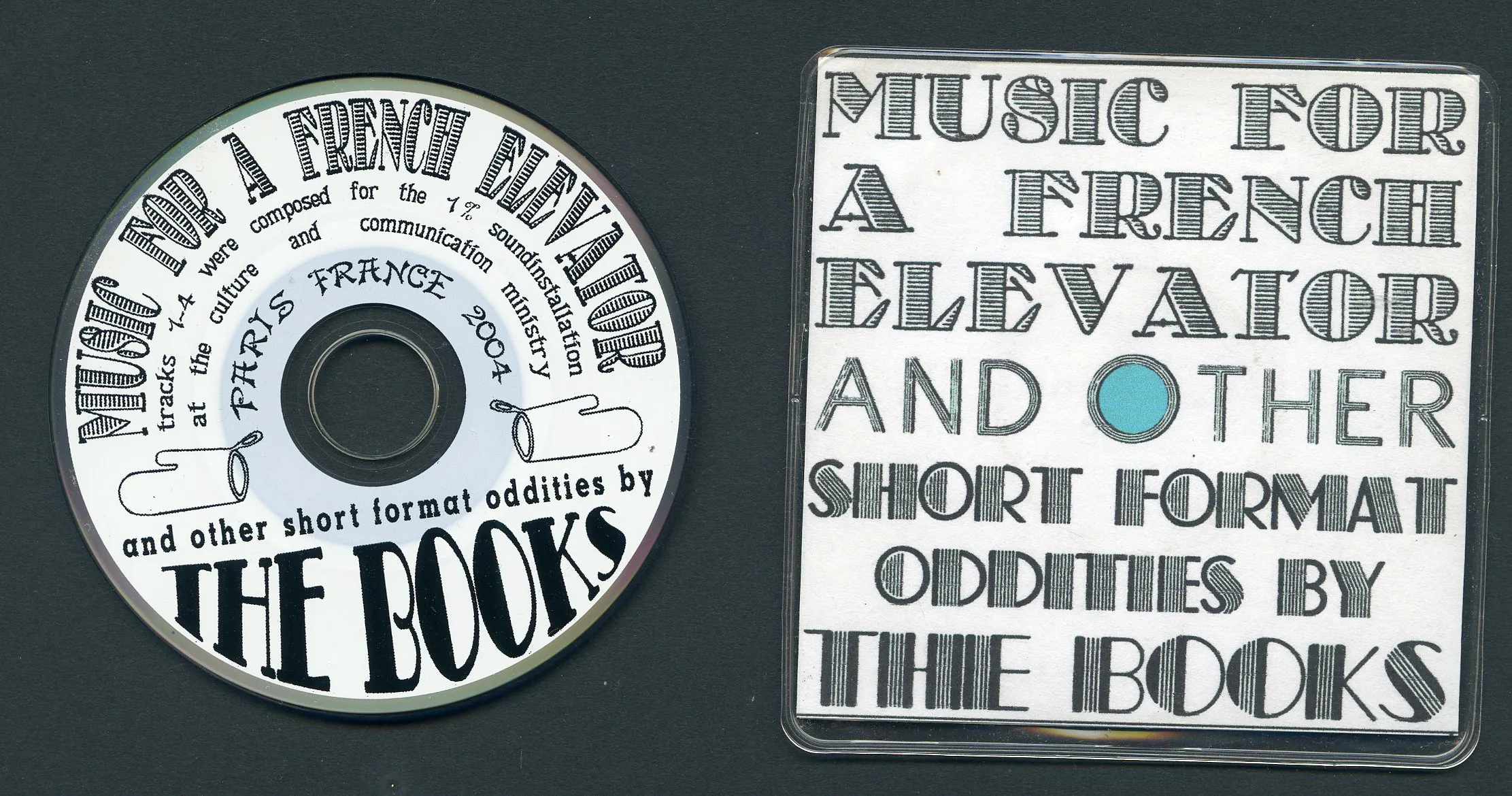 CD and cover titled Music for a French Elevator and Other Short Format Oddities by The Books, featuring detailed black text on a white background with a blue dot on the cover.